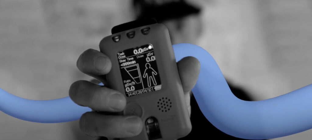 Tracerco personal electronic dosimeter, PED Blue, black and white image with blue swirl