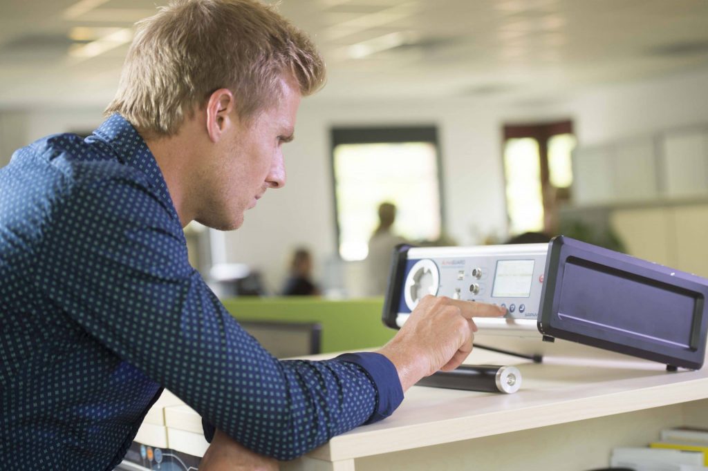 Alphaguard radon monitor from Bertin with a person operating the device inside a room